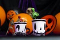 Halloween party. Skeletons coming out from the cup with balloons and skull in the background Royalty Free Stock Photo