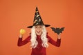 Halloween party. Small girl in black witch hat. Autumn holiday. Join celebration. Halloween attributes. Little child in Royalty Free Stock Photo