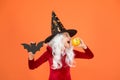 Halloween party. Small girl in black witch hat. Autumn holiday. Join celebration. Magical spell. Small witch with white Royalty Free Stock Photo