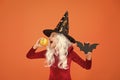 Halloween party. Small girl in black witch hat. Autumn holiday. Join celebration. Magical spell. Small witch with white