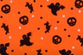 Halloween pattern background made of decorative ghost, witch, skeleton silhouette and pampkins confetti.