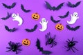 Halloween pattern concept. Flying black paper bats , pumpkins and ghosts, on purple background