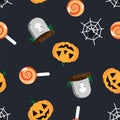 Halloween pattern grave in cemetery, orange pumpkin, spider and cobweb, sweet candy lollipop on dark background. Happy Royalty Free Stock Photo