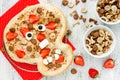 Halloween pizza recipe for kids, sweet tart skull with strawberry peanut butter and cereal snack