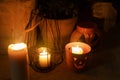 Halloween porch and entrance decor. Spooky Jack o lantern, spiders, pumpkin and glowing candles in bucket in dark. Scary halloween Royalty Free Stock Photo