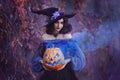 Halloween portrait fantasy woman witch. Girl sorceress in vintage purple costume medieval dress, tall cone hat. Magician Royalty Free Stock Photo