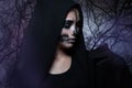 Halloween portrait of young beautiful girl in a black hood. Royalty Free Stock Photo