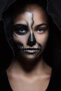 Halloween portrait of young beautiful girl in a black hood. skeleton makeup Royalty Free Stock Photo