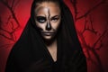 Halloween portrait of young beautiful girl in a black hood. skeleton makeup half face. Royalty Free Stock Photo