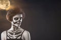 Halloween. Portrait of young beautiful girl with make-up skeleton on her face Royalty Free Stock Photo