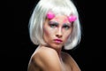 Halloween. Portrait of young beautiful girl with make-up. With white hair and pink devil horns. Isolated on black