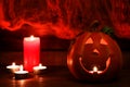 Halloween postcard. Jack-o-latern and candles against the background of a cobweb with two spiders. Selective focus