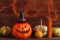Halloween postcard. Jack-o-latern with decorative pumpkins and candle against the background of a cobweb with two spiders. Royalty Free Stock Photo