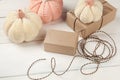 Halloween preparation. Halloween background with decorative pumpkin, gift box on white wooden background. Festive concept.