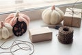 Halloween preparation. Craft halloween gift boxes on the window sill. Holidays, decoration and party concept - home room