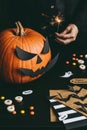 Halloween preparation. Hands making halloween cards using craft paper