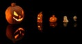 Halloween pumpkin with burning candles on black background Royalty Free Stock Photo