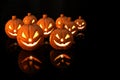 Halloween pumpkin with burning candles on black background Royalty Free Stock Photo