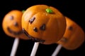 Halloween pumpkin cake pops isolated on a black. horizontal Royalty Free Stock Photo