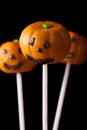 Halloween pumpkin cake pops isolated on a black. Vertical Royalty Free Stock Photo