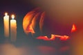 Halloween Pumpkin And Candle In Darkness. Spooky Vintage Photo. Carved Pumpkin With Scary Face And Orange Glow