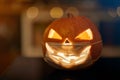 Halloween pumpkin with a carved face; Corona virus halloween concept