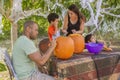 Halloween pumpkin carving is a family tradition in the backyard
