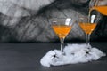 Halloween Pumpkin Cocktail, Toxic Orange Drink Decorated with Spiders and Cobweb on Dark Background Royalty Free Stock Photo