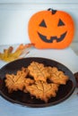 Halloween pumpkin cookies and autumn leaves. Halloween decoration. Trick or treat. Traditional October still life.