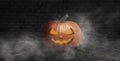 Halloween pumpkin on a dark background with smoke and fog at night Royalty Free Stock Photo