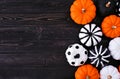 Halloween pumpkin decor side border. Orange, black and white patterns against a black wood background. Copy space. Royalty Free Stock Photo