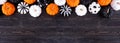 Halloween pumpkin decor top border. Orange, black and white patterns against a black wood banner background. Copy space. Royalty Free Stock Photo