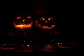 Halloween pumpkin on a dj table with headphones on dark background with copy space. Happy Halloween festival decorations and music