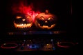 Halloween pumpkin on a dj table with headphones on dark background with copy space. Happy Halloween festival decorations and music