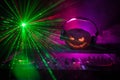 Halloween pumpkin on a dj table with headphones on dark background with copy space. Happy Halloween festival decorations and music Royalty Free Stock Photo