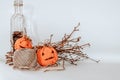 Halloween Pumpkin Embroideries, Tree Branches, A Jute Twine, And A Bottle With Nuts