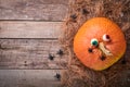 Halloween Pumpkin. Festive autumn decor from pumpkins, leaves, spider, skeletons and funny eyes on old wooden background. Flat lay