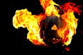 Halloween pumpkin on fire isolated on a black background Royalty Free Stock Photo