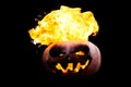 Halloween pumpkin on fire isolated on a black background Royalty Free Stock Photo