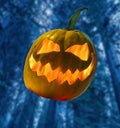 Halloween pumpkin with flame inside on abstract blurred background