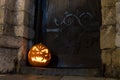 Halloween pumpkin in front of ancient wooden door and stone wall of a church, Germany Royalty Free Stock Photo