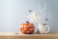 Halloween pumpkin and ghost creative decoration on wooden table