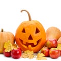 Halloween. Pumpkin head, apples and autumn yellow leaves isolated on white