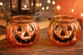 Halloween pumpkin head jack glass lantern. Halloween decoration on wooden table background, selective focus