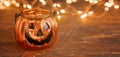 Halloween pumpkin head jack glass lantern. Halloween decoration on wooden table background, selective focus