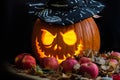 Halloween pumpkin head jack lantern in black cone-shaped hat with luminous eyes and mouth in apples and dry autumn leaves on black