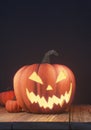 Halloween pumpkin head jack lantern on wooden planks and black background, spooky night Royalty Free Stock Photo