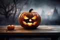 Halloween pumpkin head jack lantern on wooden table with foggy background, One spooky halloween pumpkin, Jack O Lantern, with an Royalty Free Stock Photo