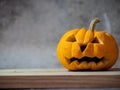 Halloween pumpkin head jack lantern on wooden table