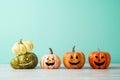 Halloween pumpkin jack o lantern decor with funny face on wooden table over blue background Royalty Free Stock Photo